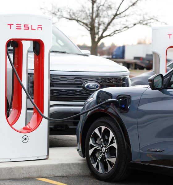 ford mustang mach-e plugged into a tesla supercharger